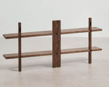 A wall-mounted bookshelf with two tiers of shelving. The unit features a central vertical support an… — 3D model