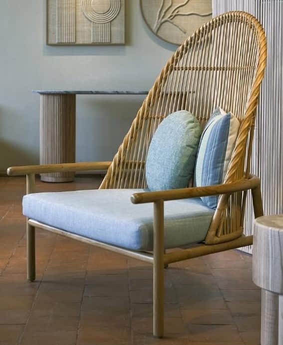 A contemporary lounge chair featuring a light-toned solid wood frame and an intricately woven natura… — 3D model