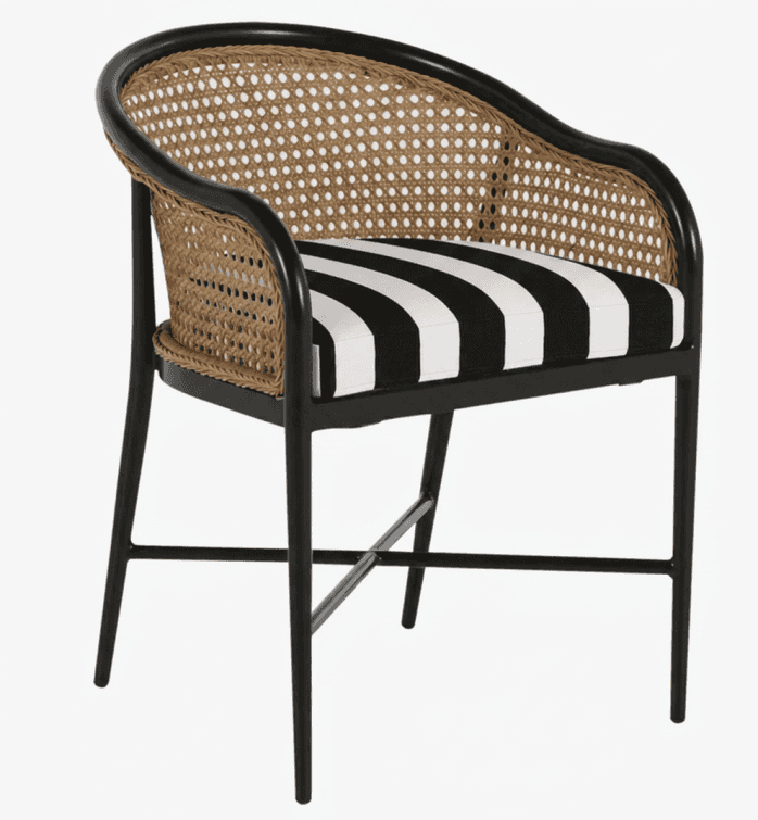 A modern dining chair featuring a black frame, a curved backrest with natural cane webbing, and a re… — 3D model