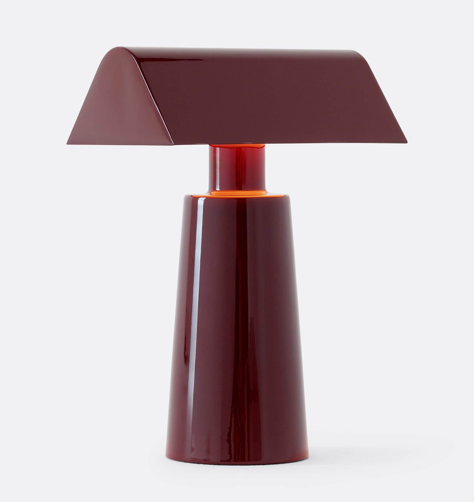 A modern table lamp featuring a distinctive trapezoidal shade and a conical base, both finished in a… — 3D model
