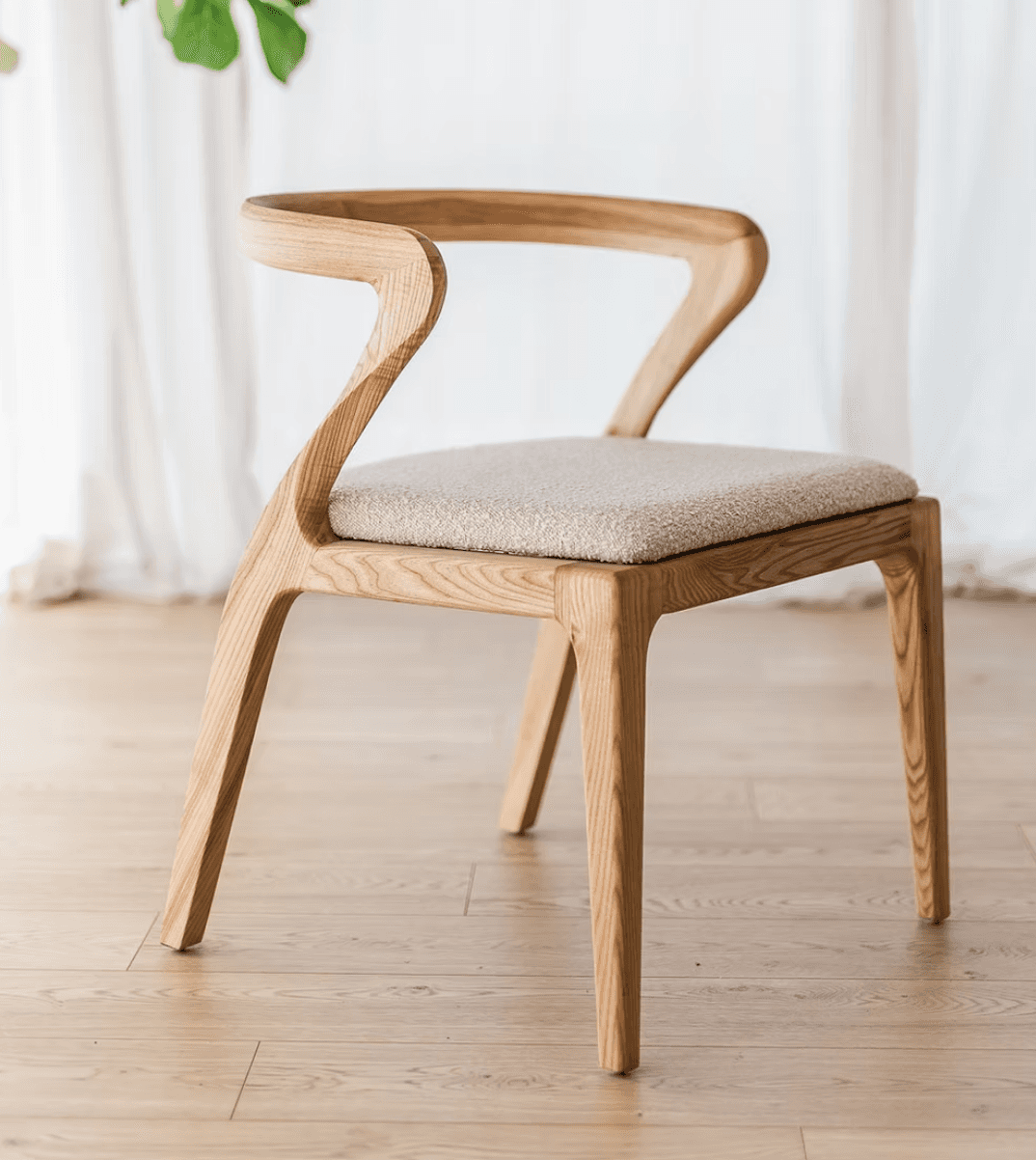 A modern wooden chair with a sculpted, flowing design. The chair features a curved backrest that ext… — 3D model