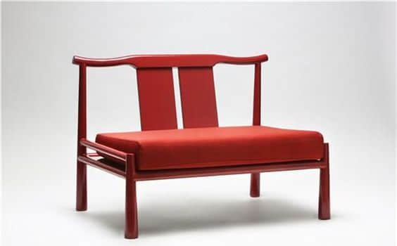 A modern two-seater bench with a vibrant red finish, featuring a distinctive yoke-back design inspir… — 3D model