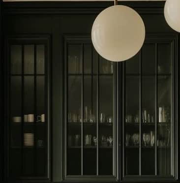 A minimalist spherical lamp shade crafted from opal glass, featuring a small, polished brass cap at… — 3D model