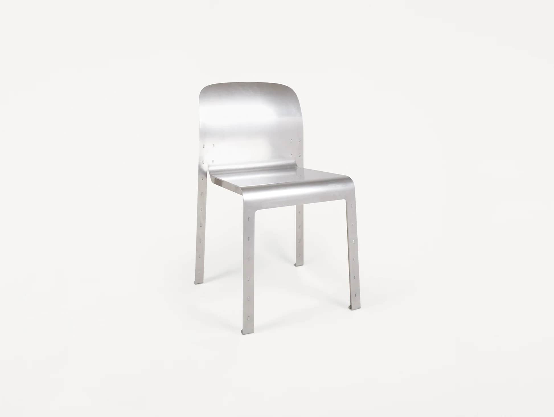 A minimalist, industrial-style chair constructed from brushed aluminum, featuring a seamlessly curve… — 3D model
