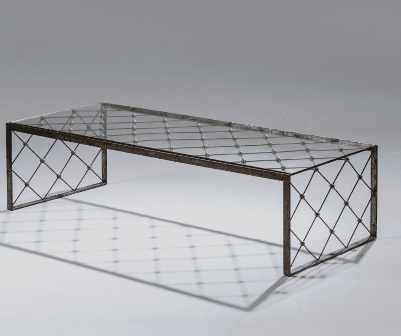 A rectangular coffee table with a glass top and a metal base. The base features a crisscross pattern… — free FBX 3D model