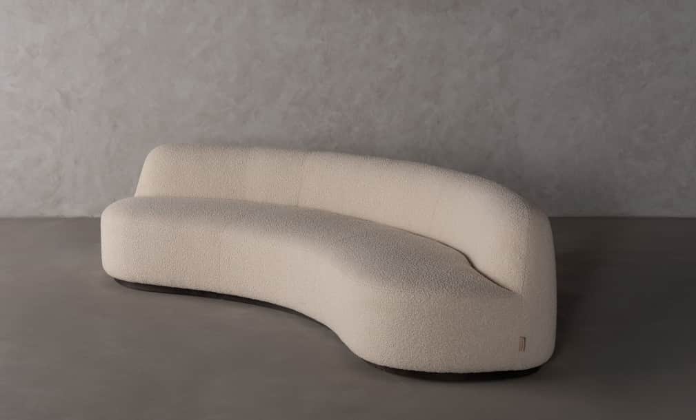 A contemporary curved sofa with a textured upholstery and a flowing, organic shape. The sofa feature… — 3D model