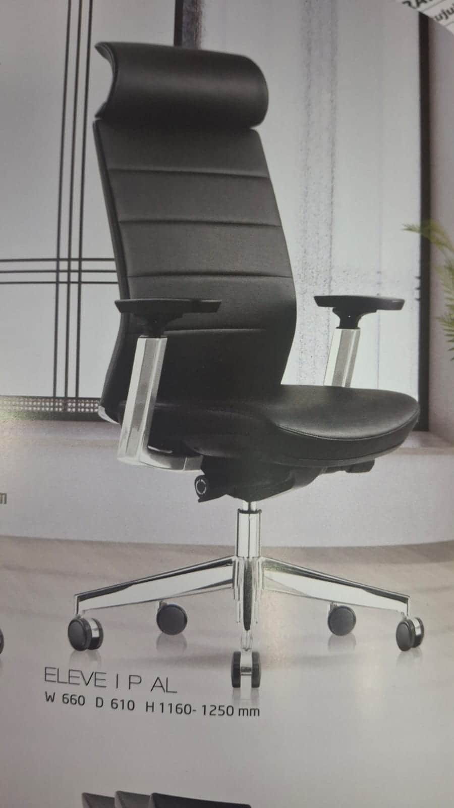 A high-back executive office chair upholstered in black faux leather, featuring an integrated headre… — 3D model