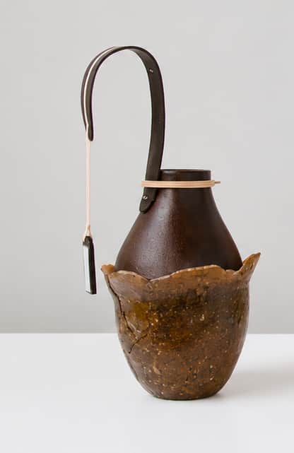 A unique dual-tone decorative vessel featuring an organic, textured outer shell in an earthy brown h… — 3D model