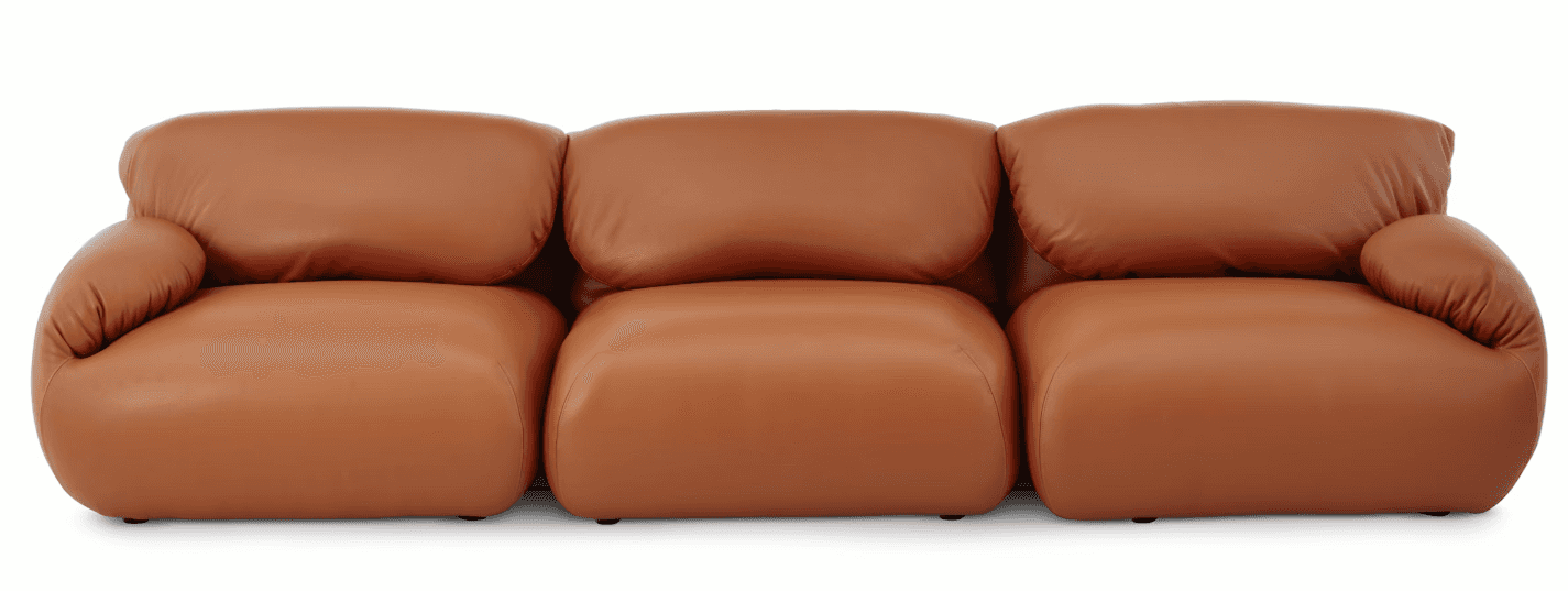 A three-seater sofa upholstered in smooth, tan-colored leather. The sofa features plush, overstuffed… — free GLTF 3D model