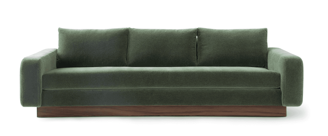 A modern three-seater sofa with green fabric upholstery and a prominent dark wood plinth base. It fe… — 3D model