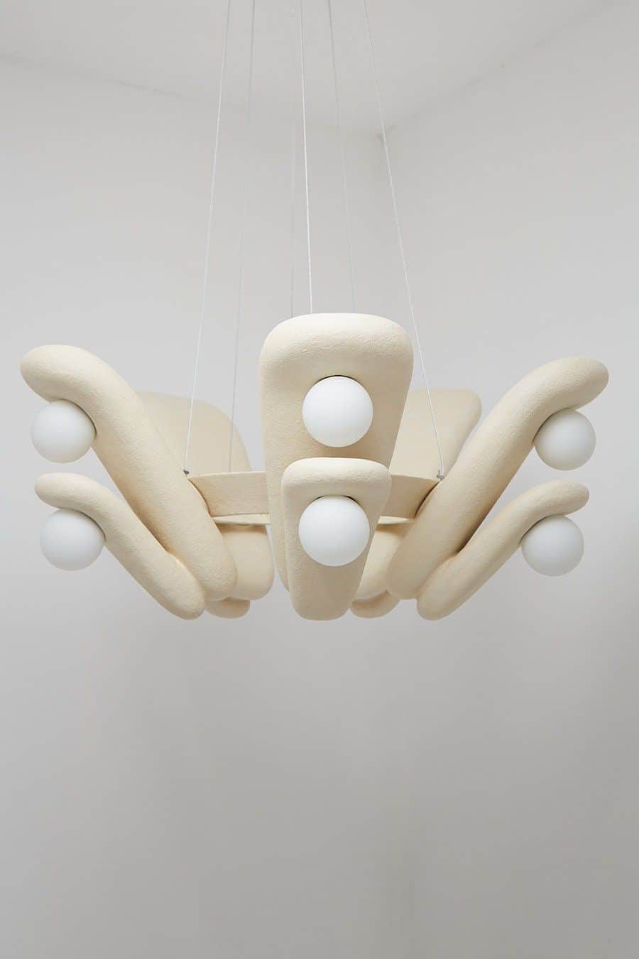 A modern chandelier with an organic, sculptural design. It features a central cluster of bulbous for… — 3D model