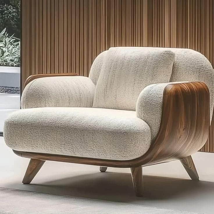 A contemporary armchair featuring a soft, textured off-white upholstery complemented by sculpted dar… — free GLTF 3D model