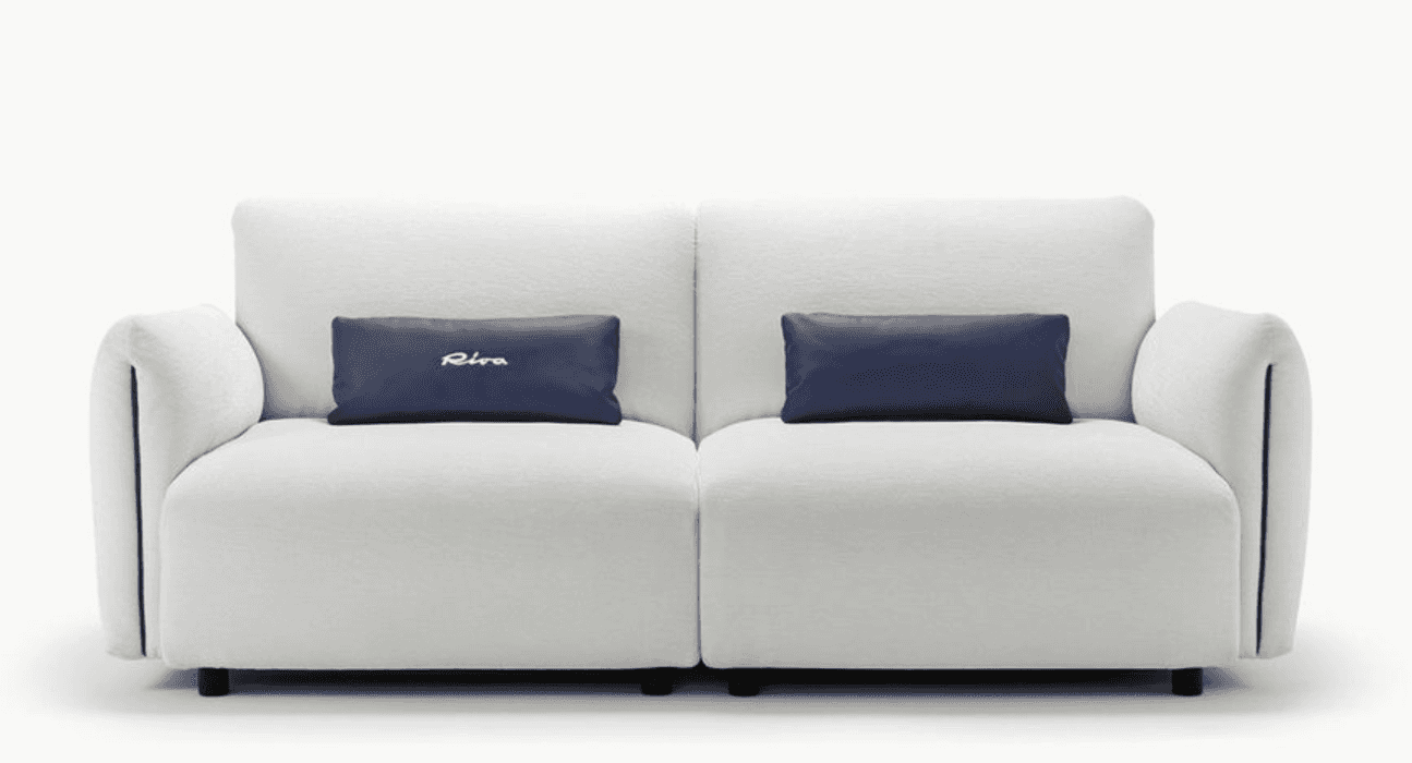 A two-seater sofa with plush white upholstery and two rectangular dark blue accent pillows. The sofa… — 3D model
