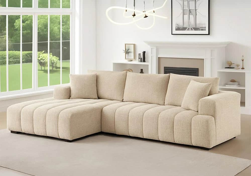 A modern L-shaped sectional sofa with a fixed left-hand chaise, upholstered in a light-colored woven… — 3D model