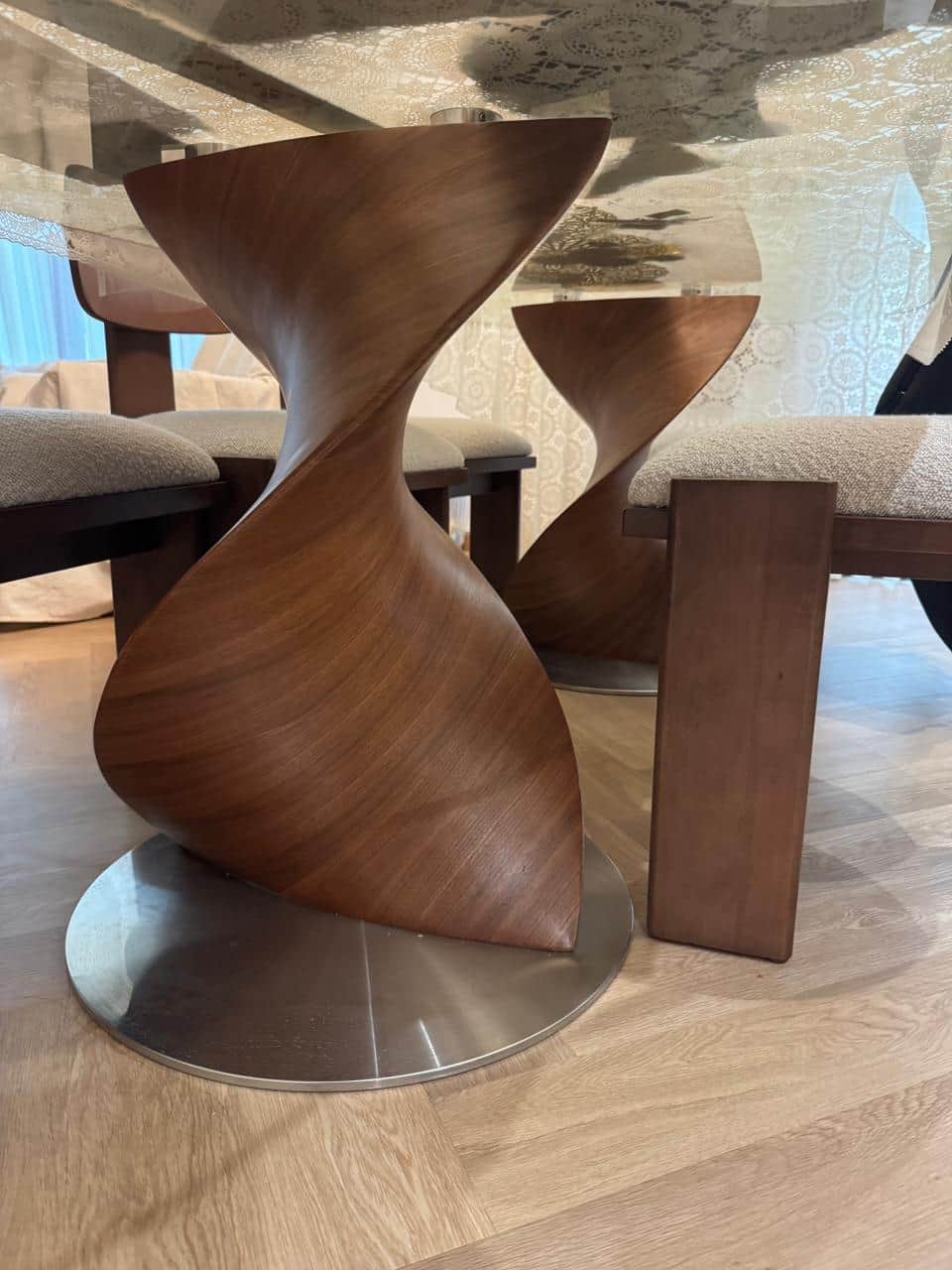 A modern sculptural accent table featuring a unique twisted, hourglass-like form crafted from rich w… — 3D model