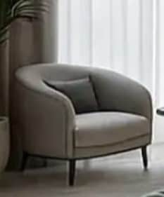 A contemporary upholstered armchair with a rounded barrel back, light beige fabric, dark piping deta… — 3D model
