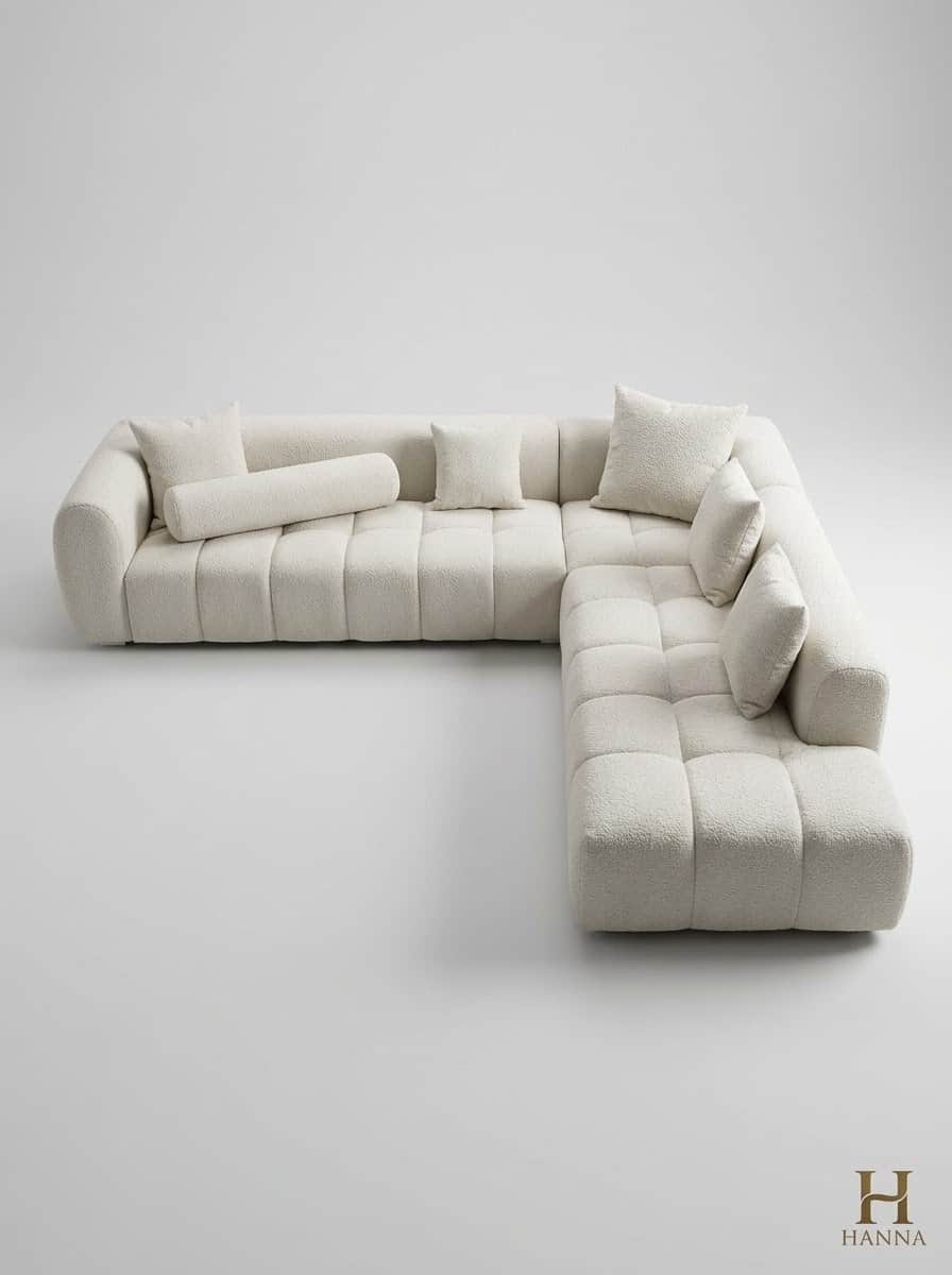 An L-shaped modular sectional sofa upholstered in an off-white bouclé fabric. It features a low-prof… — free GLTF 3D model