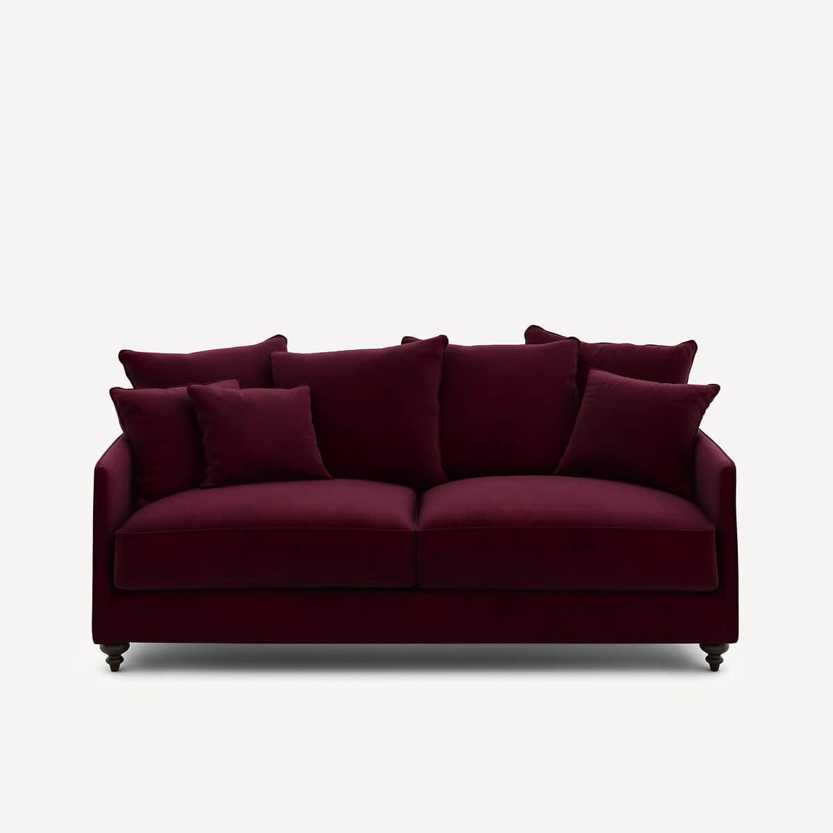 A deep burgundy velvet sofa with multiple loose back cushions and two seat cushions. The sofa has a… — 3D model