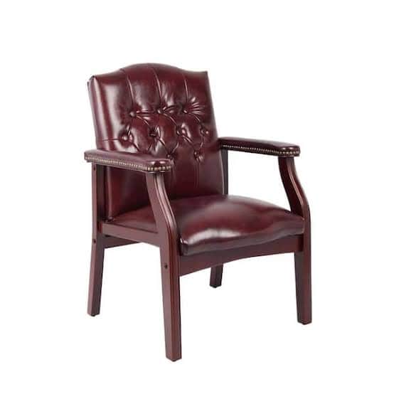 A traditional style armchair featuring burgundy leather upholstery with deep button tufting on the b… — 3D model