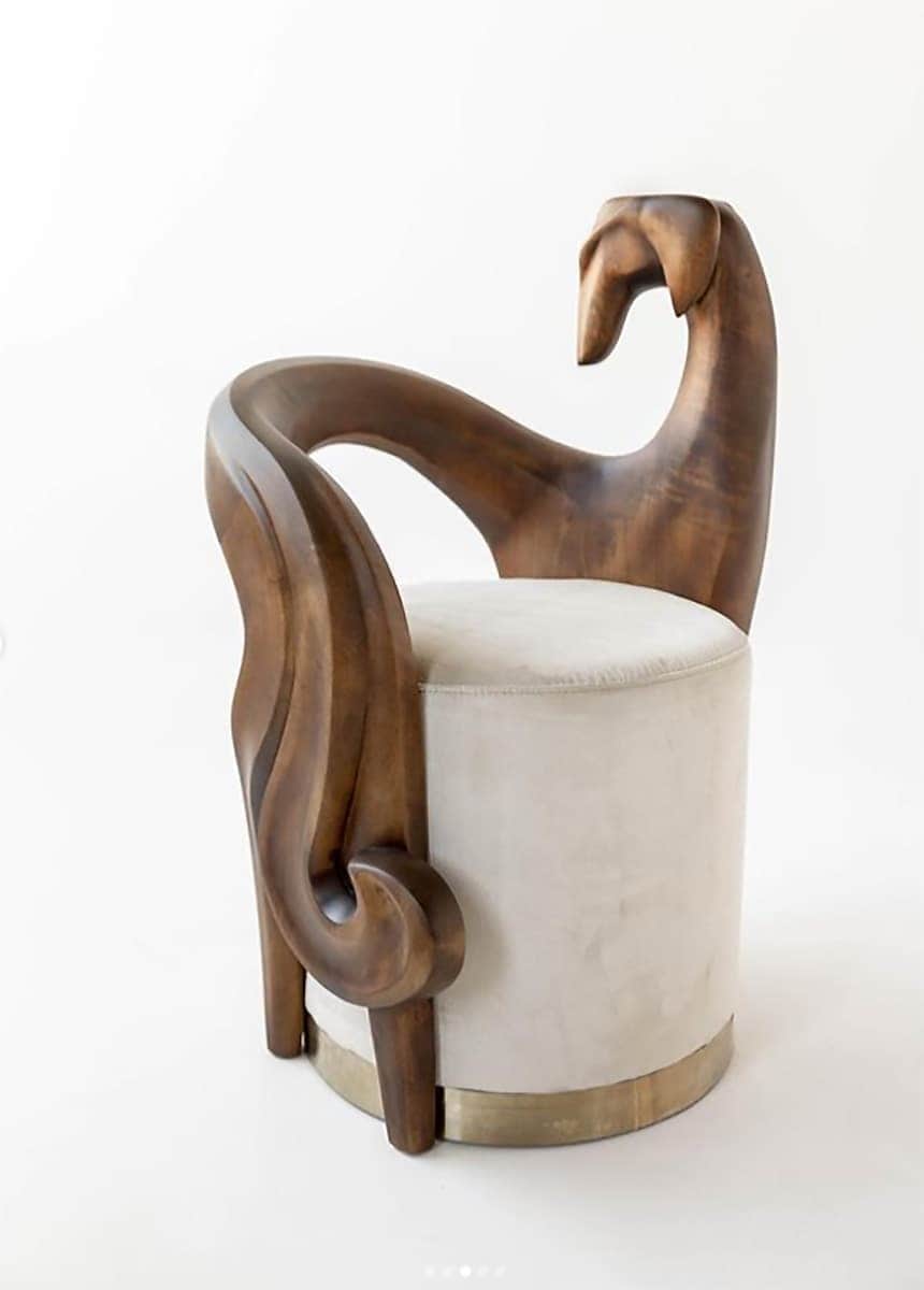 A highly sculptural armchair featuring a dark wood frame with organic, sweeping lines and a distinct… — free OBJ 3D model