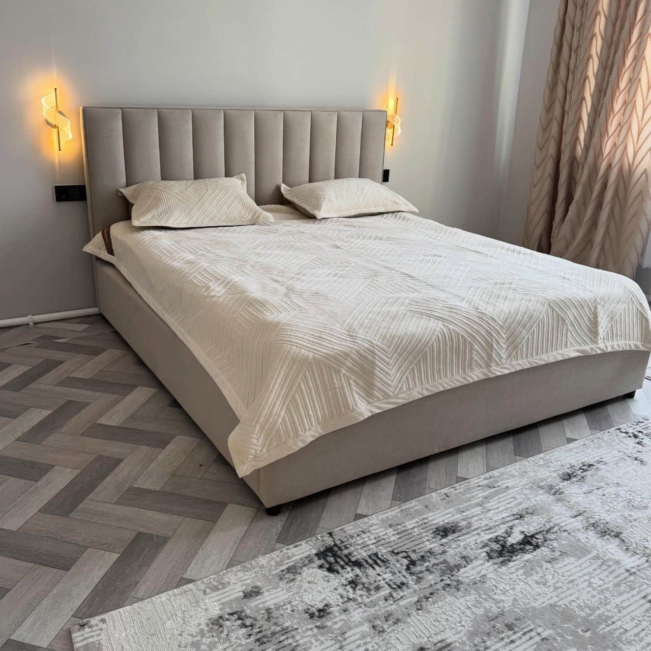 A modern upholstered platform bed featuring a tall headboard with vertical channel tufting. The enti… — free GLTF 3D model