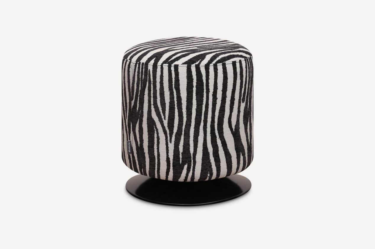 A cylindrical ottoman upholstered in a distinctive black and white zebra print fabric, featuring a f… — 3D model