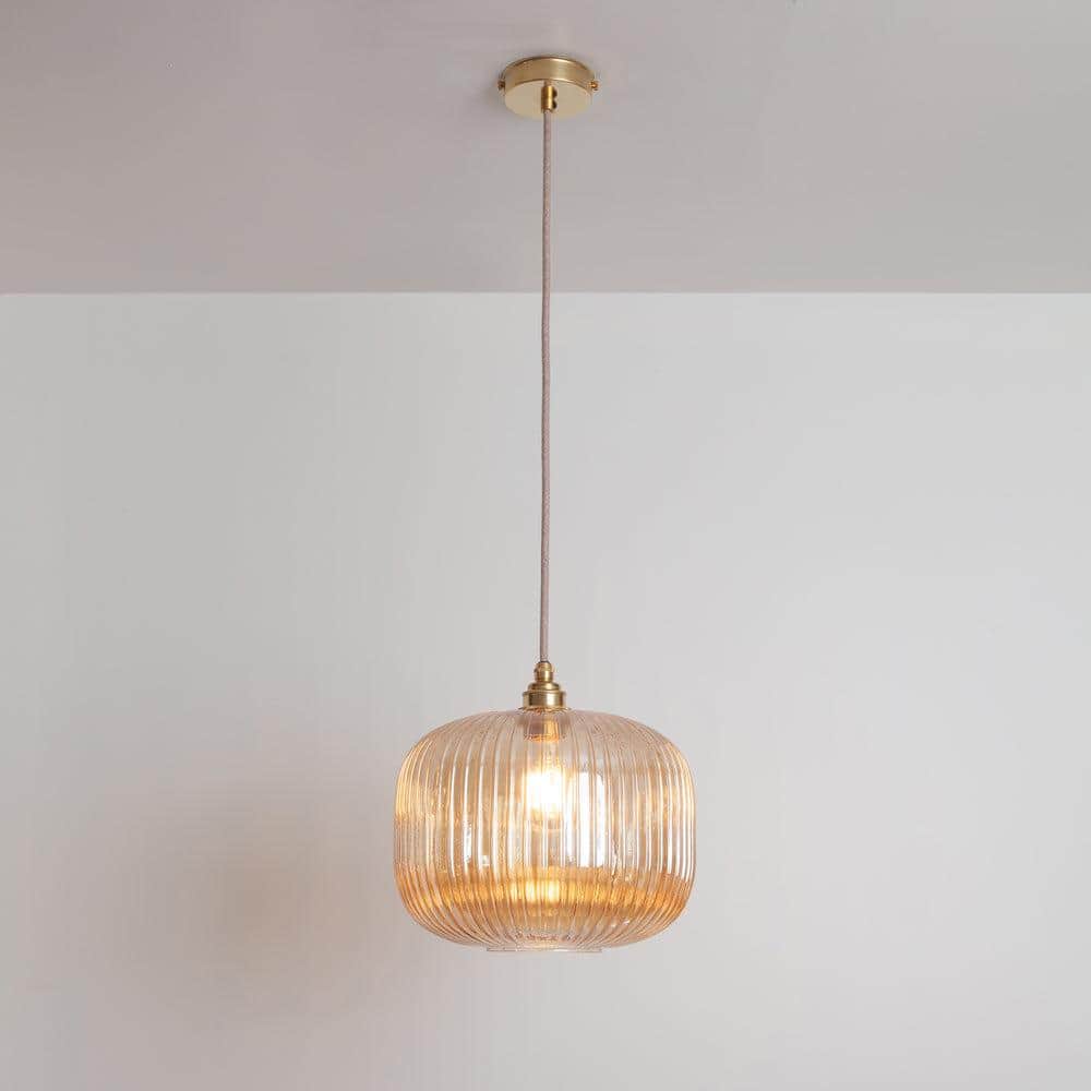 A single amber ribbed glass pendant light featuring brass hardware for mounting and suspension. The… — 3D model