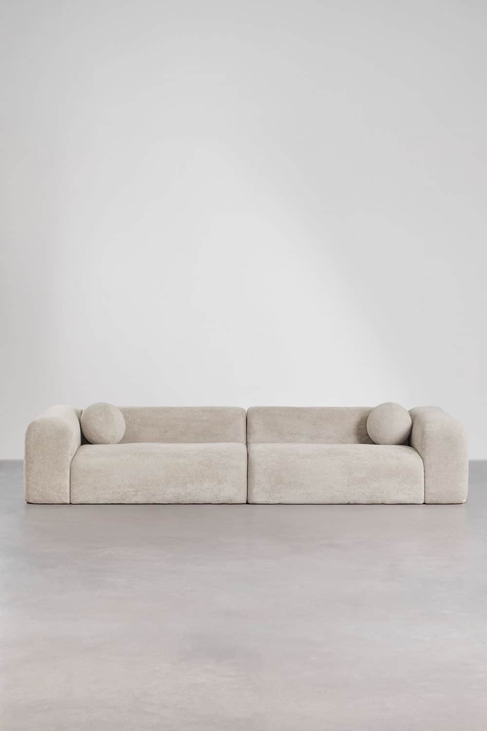A two-piece modular sofa upholstered in a light beige boucle fabric, featuring a low-slung profile,… — 3D model