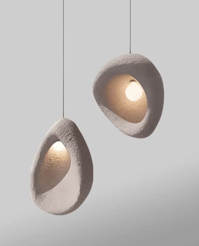 A single pendant light featuring an irregularly shaped, organic shade made from light gray, textured… — 3D model