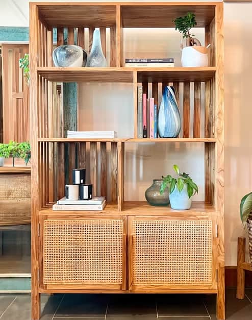 A tall, rectangular bookshelf crafted from light-toned natural wood, featuring multiple open shelvin… — 3D model