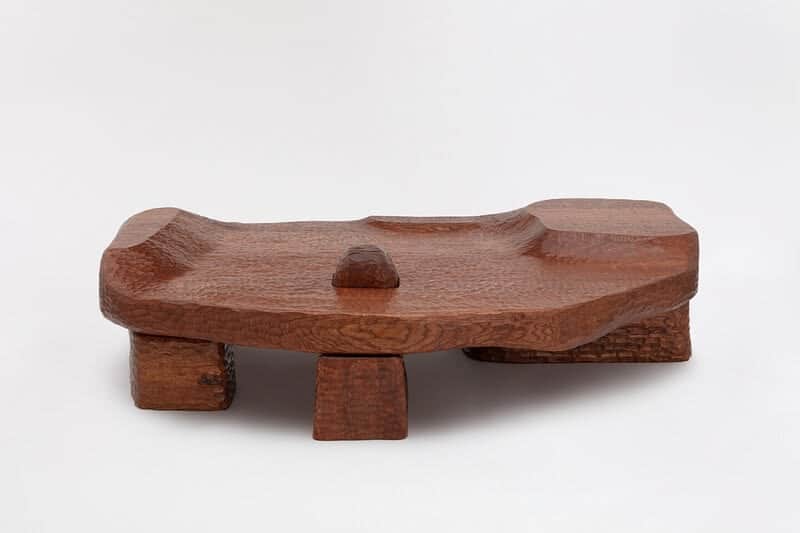 A unique, low-profile coffee table carved from wood. The tabletop features an organic, undulating su… — 3D model