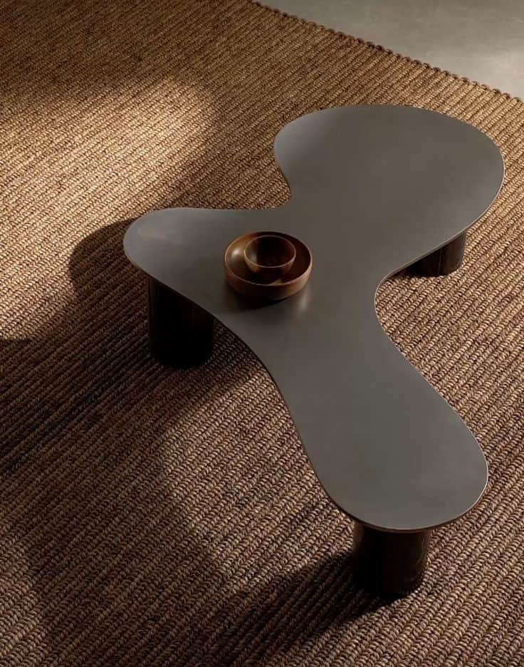 A low-profile, modern coffee table featuring an irregularly shaped top, resembling an organic or kid… — 3D model
