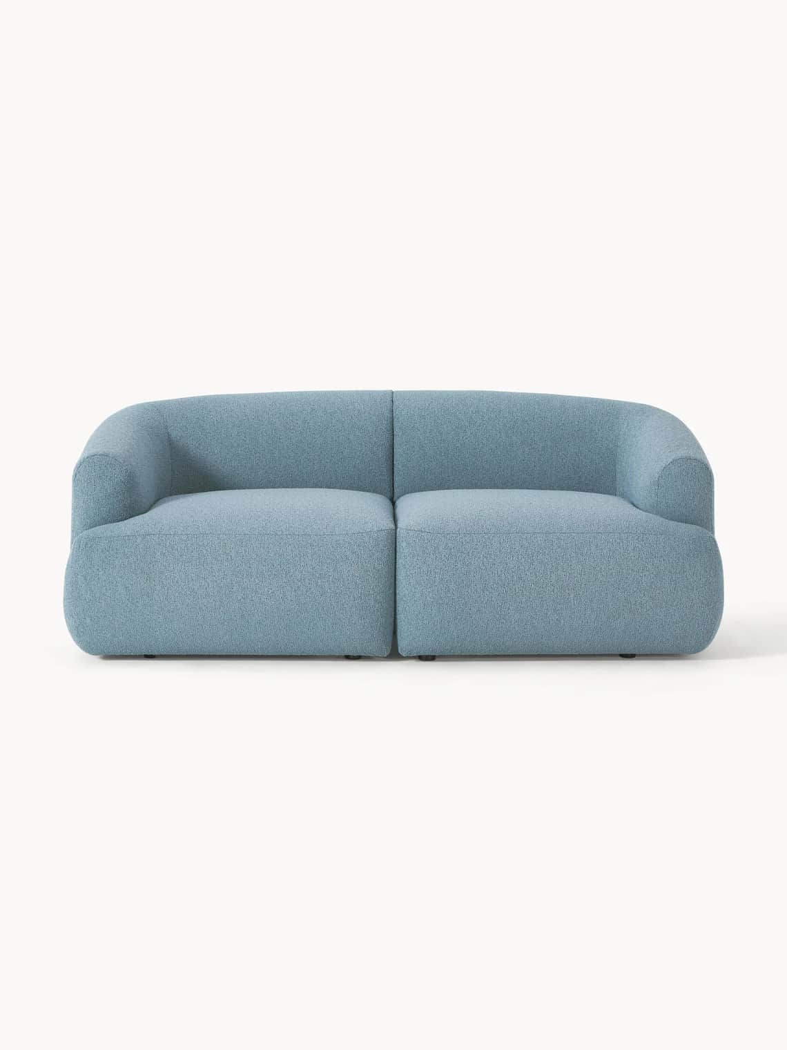 A light blue upholstered sofa with a curved back and armrests. The sofa appears to be modular, with… — free GLTF 3D model