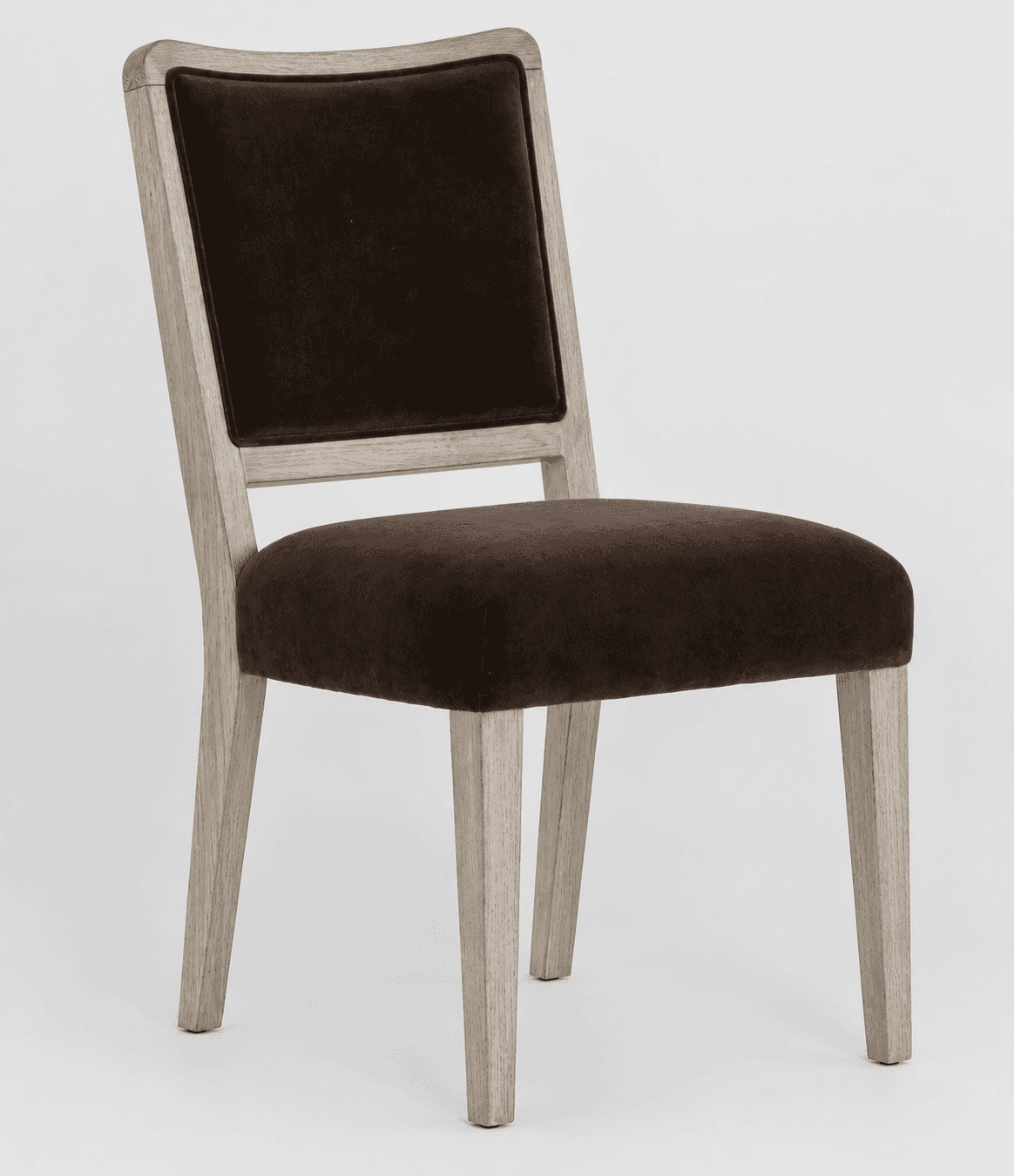 A contemporary dining chair featuring a light-toned wooden frame and dark brown velvet upholstery. T… — 3D model