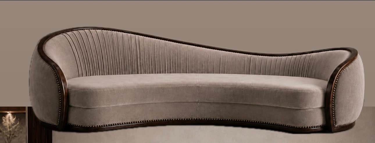 A gracefully curved sofa upholstered in a light beige velvet, featuring a prominent dark wood trim w… — free SKP 3D model