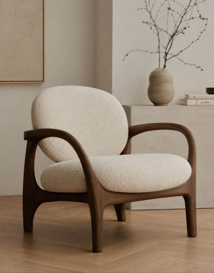 A contemporary lounge chair featuring a sculptural dark wood frame and plush, rounded bouclé upholst… — 3D model