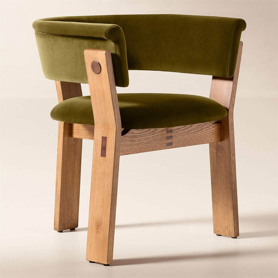 A sturdy, craftsman-style armchair featuring a robust natural oak frame and plush olive green velvet… — 3D model