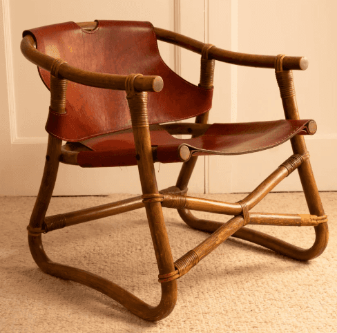 A lounge chair constructed with a curved bamboo or rattan frame. The seat and backrest are made of b… — 3D model