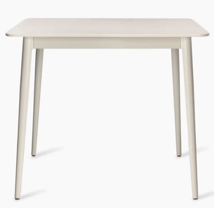 A square-shaped dining table with rounded corners and four tapered legs. The table has a smooth, mat… — 3D model