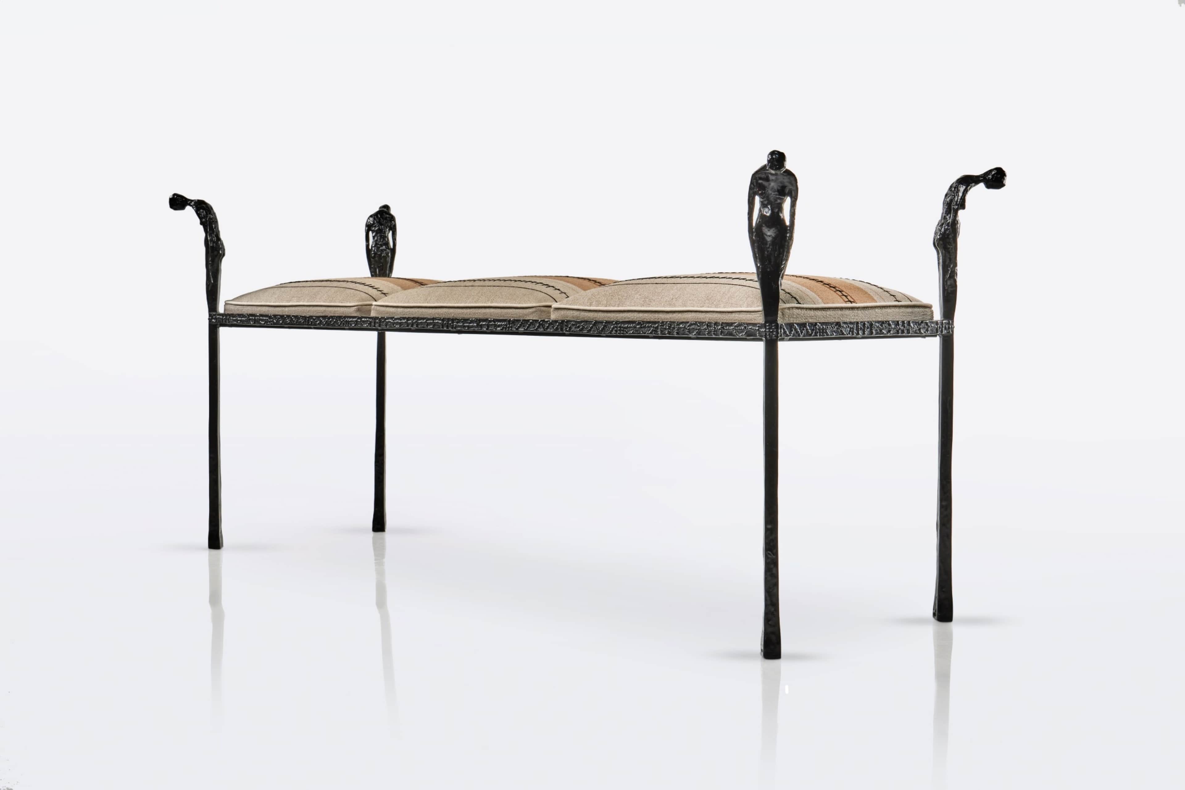 A distinctive figural wrought iron bench featuring a dark, textured metal frame with decorative upri… — 3D model
