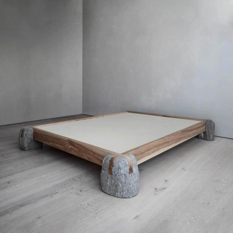 A low, square furniture piece featuring a light-colored flat top surface, a natural wood frame, and… — 3D model