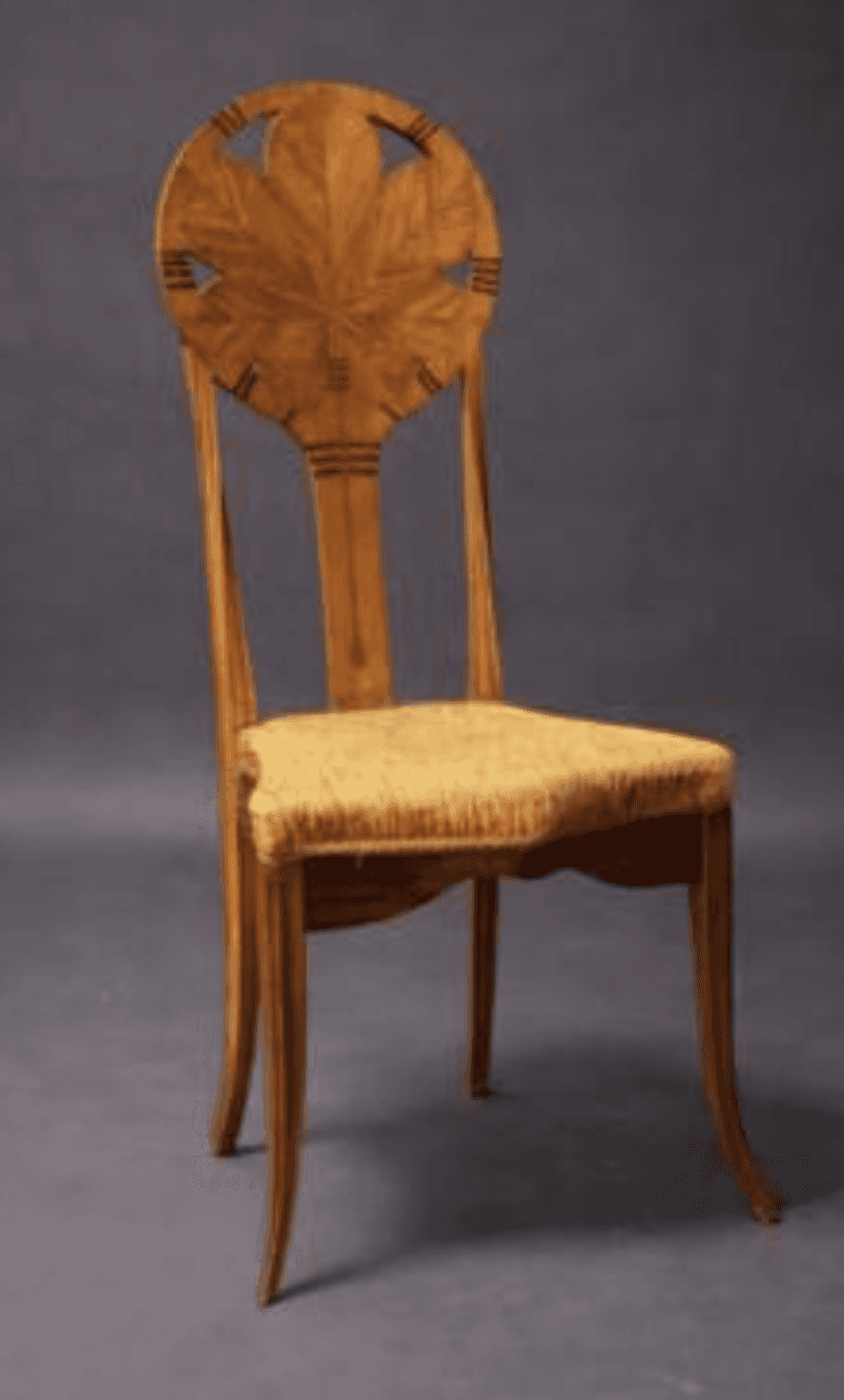 A finely crafted wooden chair with a rounded backrest featuring a carved leaf motif within a circula… — 3D model