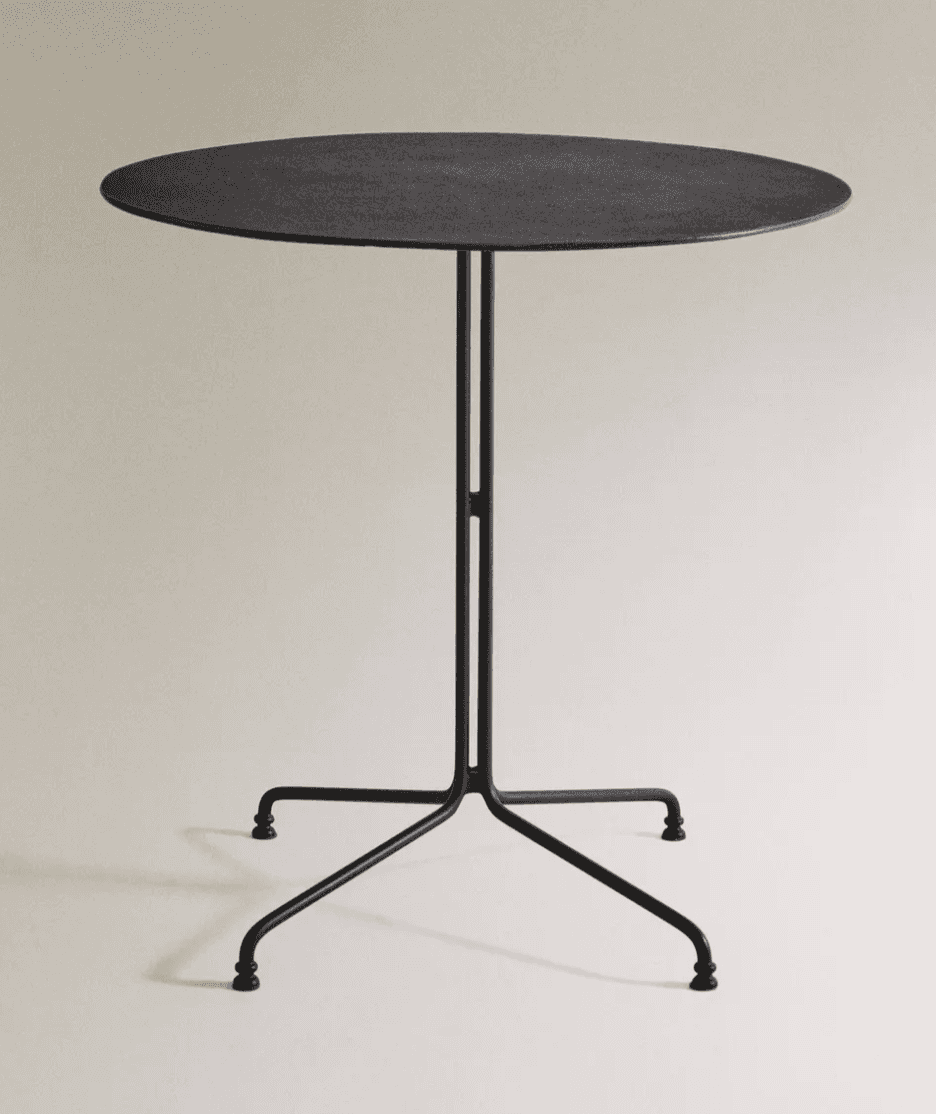 A minimalist side table with a round, flat top and a slender, dark-colored pedestal base. The base h… — 3D model