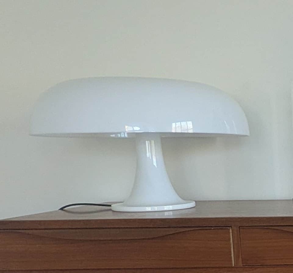 A matte white table lamp with a mushroom-shaped design. The lamp features a domed shade supported by… — 3D model