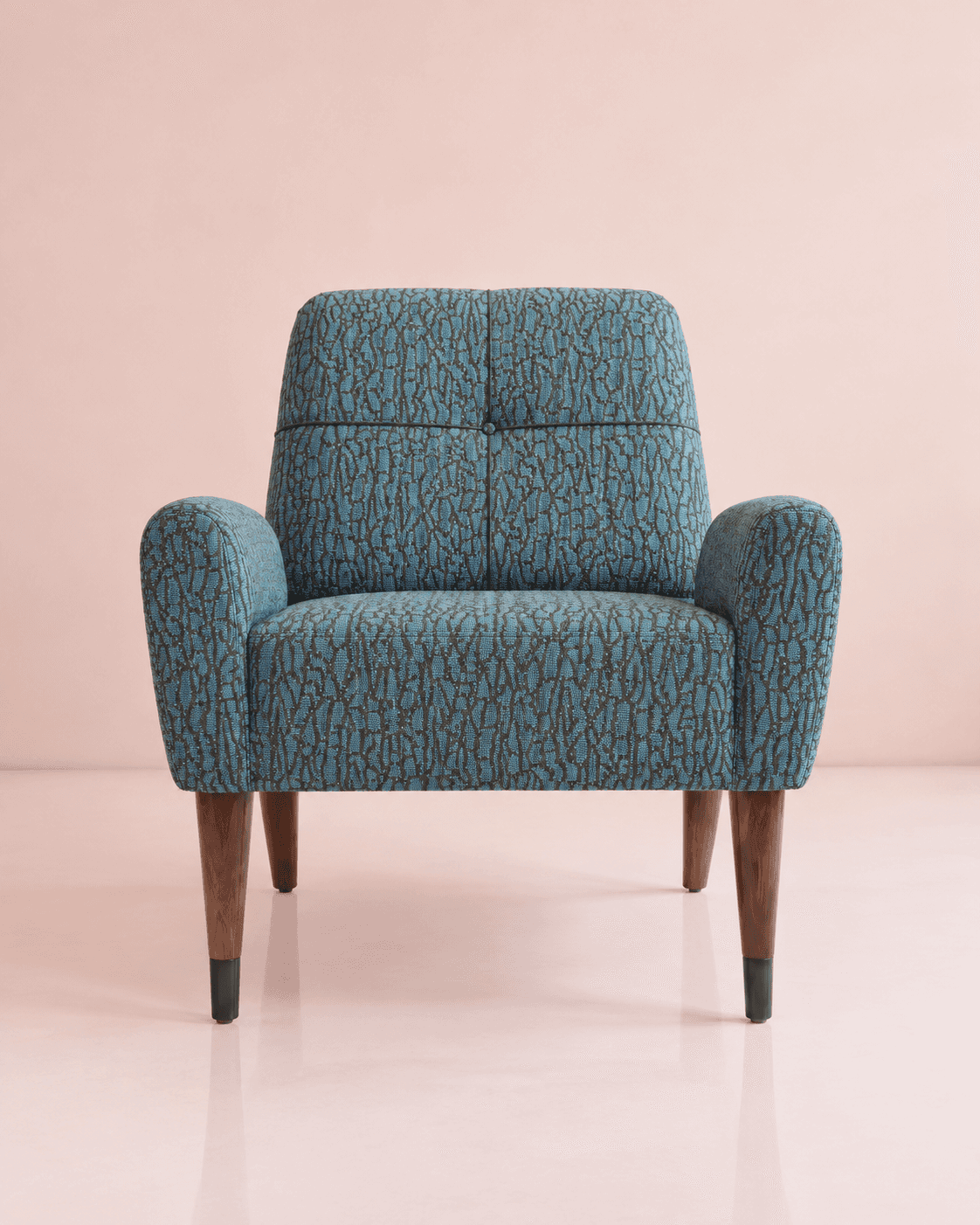 A retro-inspired armchair featuring a distinctive patterned teal fabric upholstery and tapered woode… — 3D model