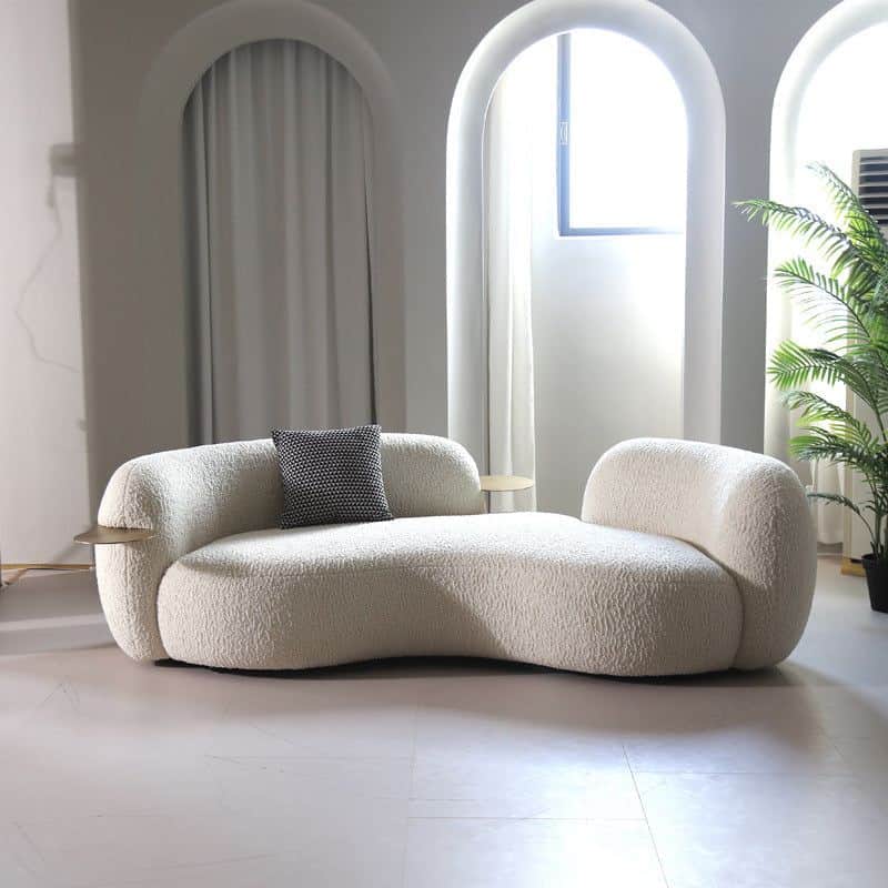 An off-white, intricately curved chaise lounge, upholstered in a textured boucle fabric. The design… — 3D model