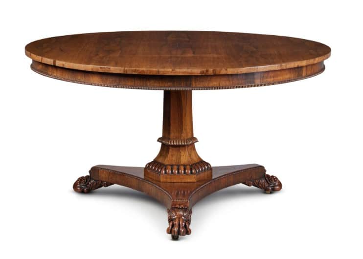 A round, wooden pedestal table with a rich, medium-brown finish. The tabletop features a finely reed… — free OBJ 3D model