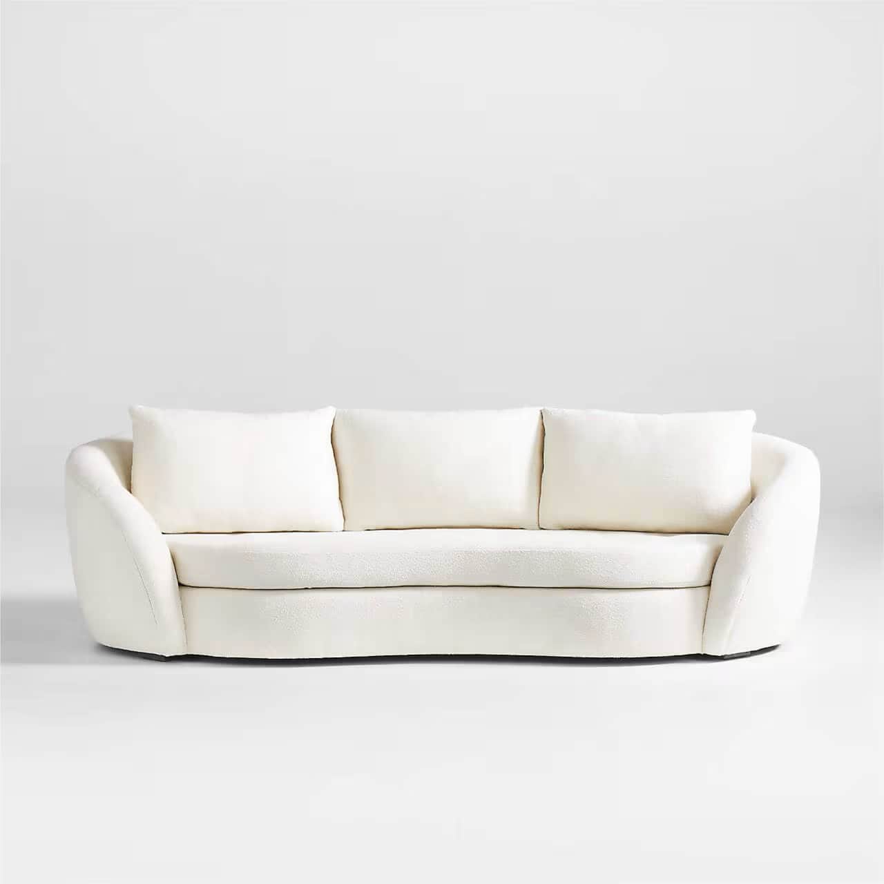 A modern three-seater sofa with a curved silhouette and plush upholstery. It features three loose ba… — free GLTF 3D model