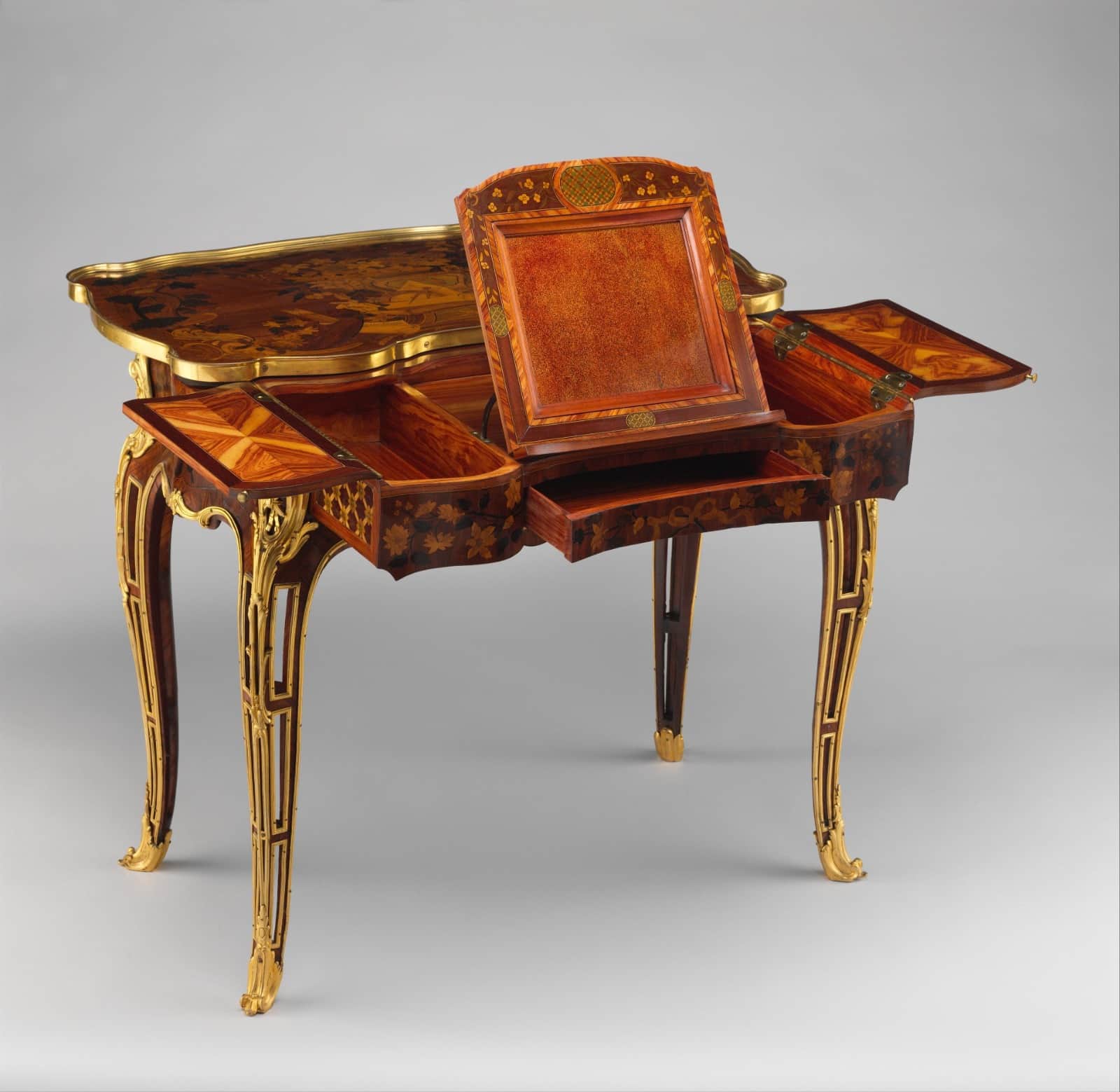 A Rococo-style marquetry table with cabriole legs and ornate gilt-bronze mounts. The table features… — free BLEND 3D model