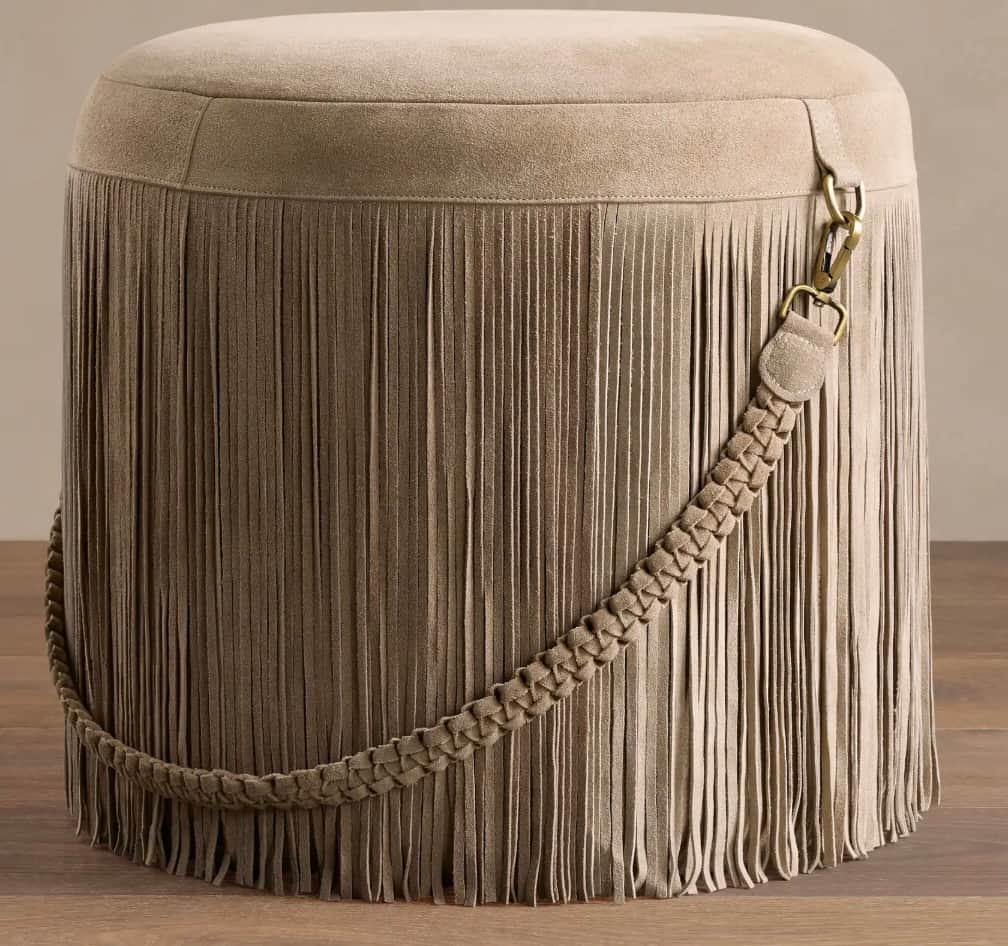 A cylindrical upholstered ottoman featuring a full skirt of cascading fringe around its perimeter. T… — 3D model